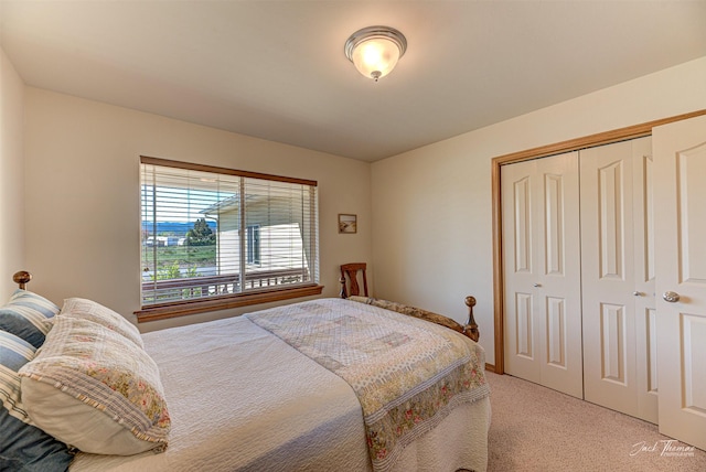 bedroom featuring light carpet and a closet