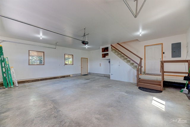 garage with electric panel and a garage door opener