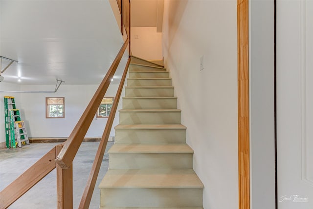 staircase with concrete floors