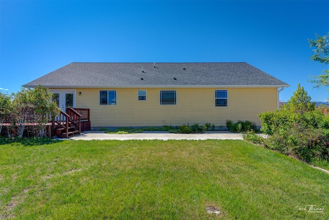 back of house with a wooden deck, french doors, and a yard