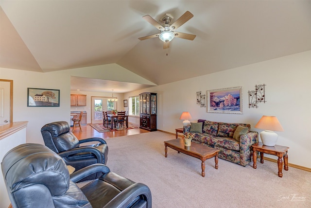 carpeted living room featuring lofted ceiling, a ceiling fan, and baseboards