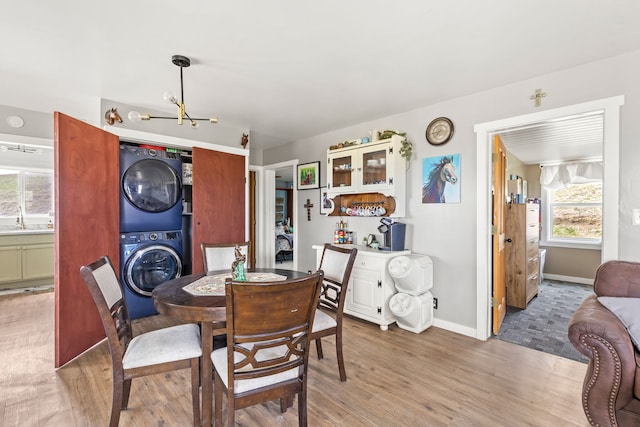 49 Embry Ln, Great Falls, MT 59404 - dining area featuring stacked washing machine and dryer and light wood finished floors