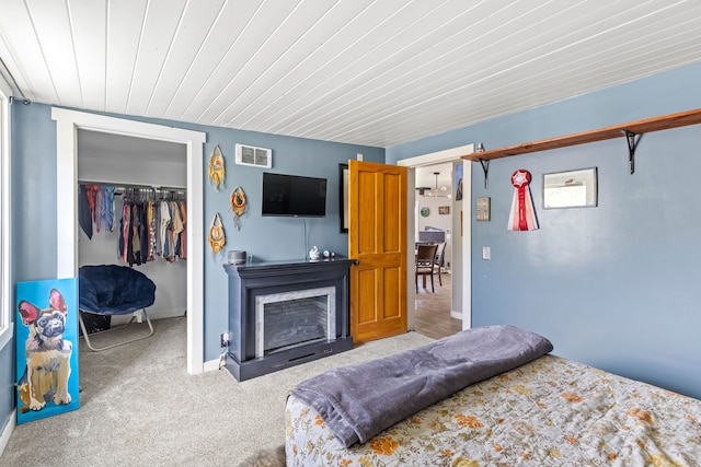 49 Embry Ln, Great Falls, MT 59404 - carpeted bedroom featuring a closet, a fireplace with flush hearth, a walk in closet, and wooden ceiling