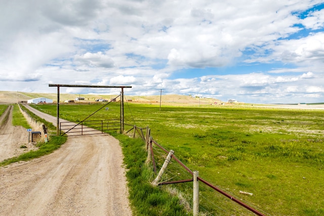 49 Embry Ln, Great Falls, MT 59404 - view of dirt / gravel road with a gate, a rural view, and a gated entry