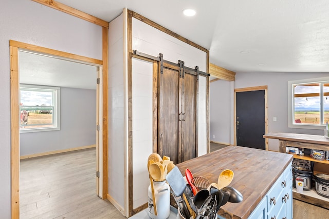 49 Embry Ln, Great Falls, MT 59404 - kitchen featuring a barn door, lofted ceiling, light wood-style floors, wood counters, and recessed lighting
