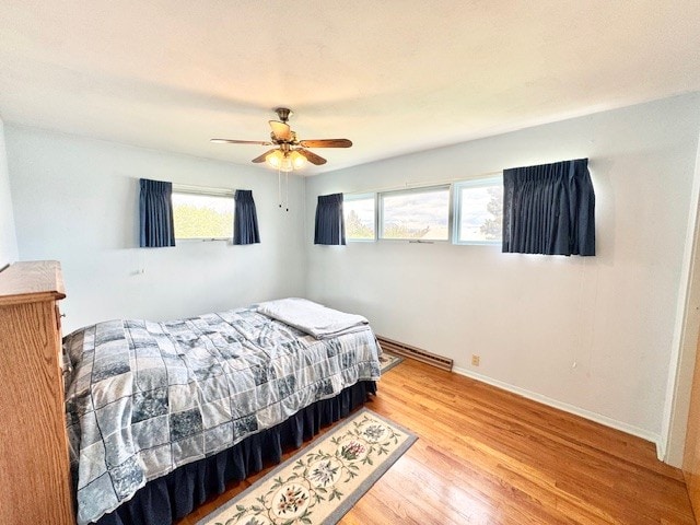 bedroom with light wood-type flooring and ceiling fan