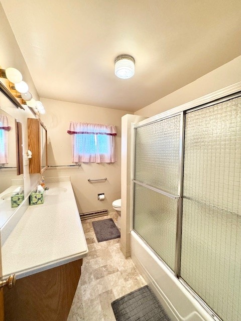 full bath featuring toilet, vanity, a baseboard heating unit, and enclosed tub / shower combo