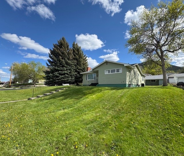 view of side of property featuring a yard