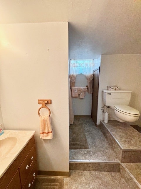 bathroom featuring toilet and vanity