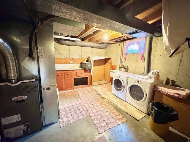 laundry area featuring separate washer and dryer and heating unit