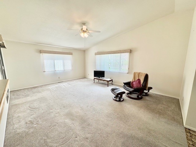 unfurnished room with a ceiling fan, baseboards, carpet flooring, and vaulted ceiling