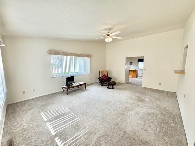unfurnished room with a ceiling fan and carpet flooring