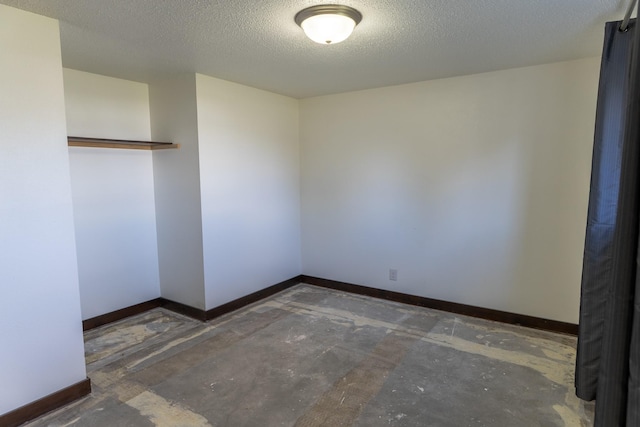 1827 Hollins Ave, Helena, MT 59601 - empty room featuring baseboards, unfinished concrete floors, and a textured ceiling