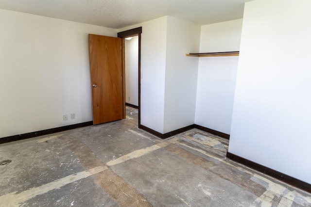 1827 Hollins Ave, Helena, MT 59601 - spare room featuring unfinished concrete flooring and baseboards