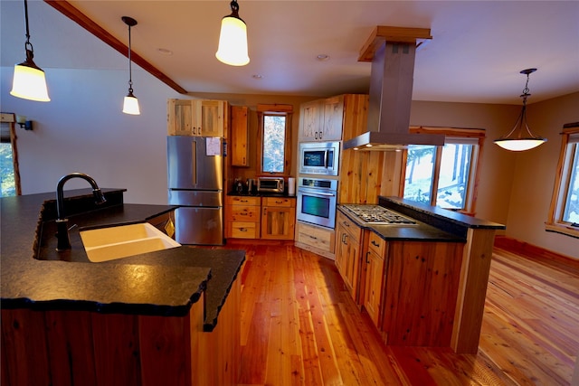 237 N Monture Ct, Seeley Lake, MT 59868 - kitchen featuring appliances with stainless steel finishes, a sink, island exhaust hood, dark countertops, and light wood-style floors