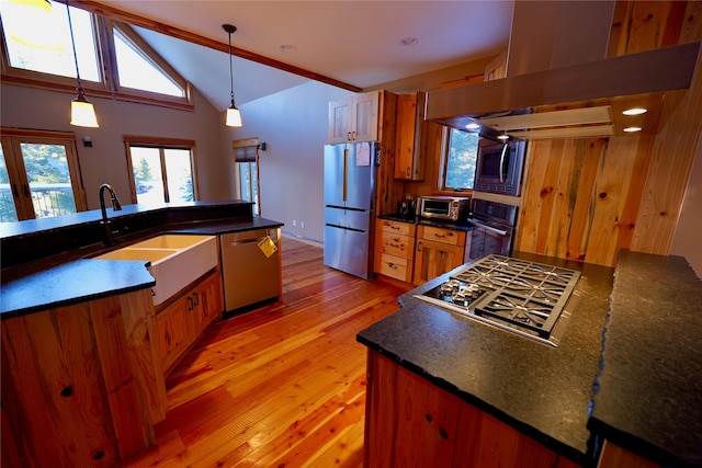 237 N Monture Ct, Seeley Lake, MT 59868 - kitchen with appliances with stainless steel finishes, dark countertops, brown cabinets, and vaulted ceiling
