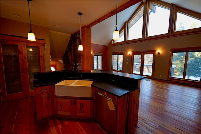 237 N Monture Ct, Seeley Lake, MT 59868 - kitchen with wood-type flooring, dark countertops, open floor plan, healthy amount of natural light, and high vaulted ceiling