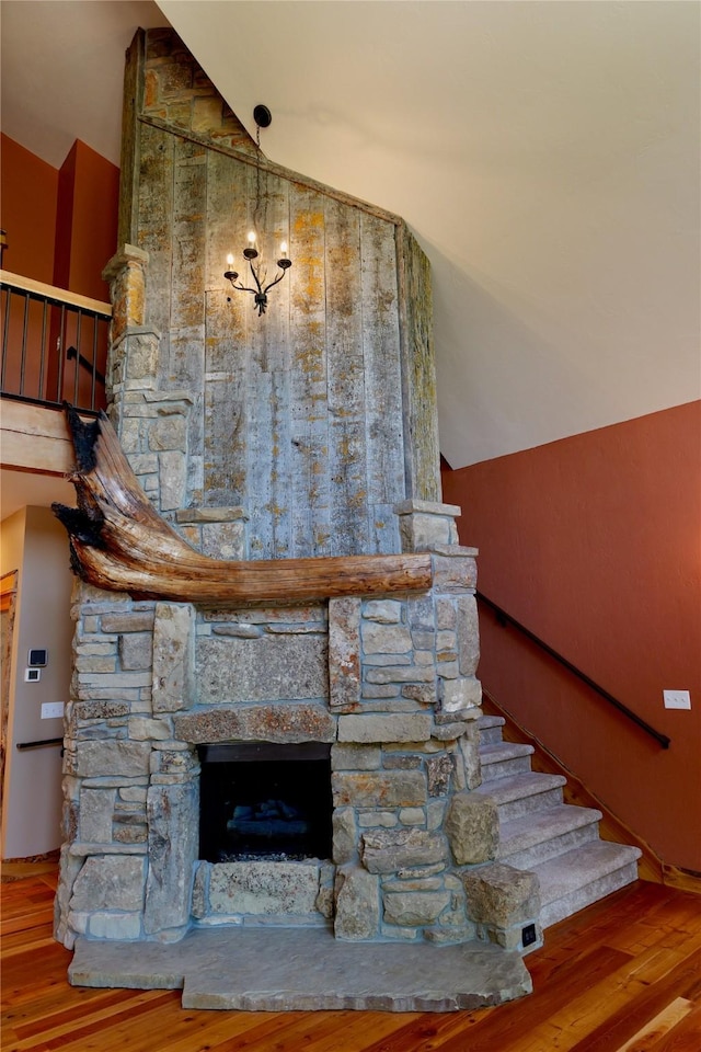 237 N Monture Ct, Seeley Lake, MT 59868 - stairway featuring vaulted ceiling, wood finished floors, and a fireplace