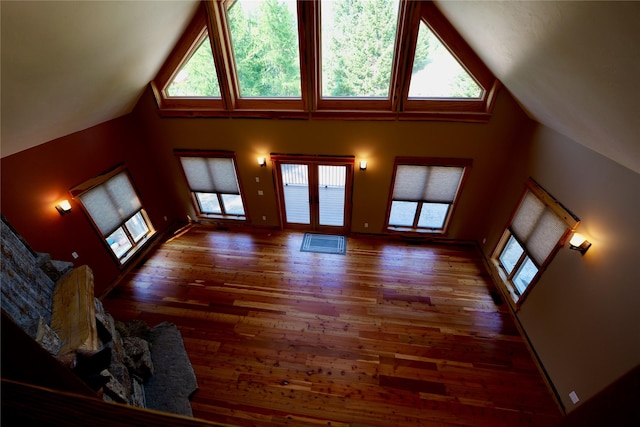 237 N Monture Ct, Seeley Lake, MT 59868 - unfurnished living room with wood finished floors and high vaulted ceiling
