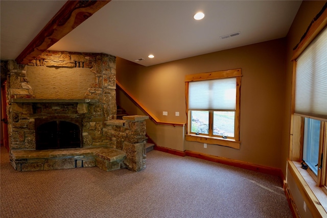 237 N Monture Ct, Seeley Lake, MT 59868 - unfurnished living room featuring carpet flooring, plenty of natural light, a stone fireplace, baseboards, and recessed lighting