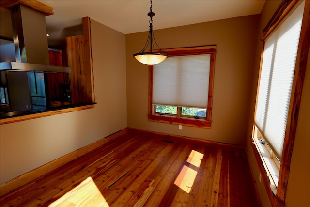 237 N Monture Ct, Seeley Lake, MT 59868 - unfurnished dining area featuring wood finished floors and baseboards