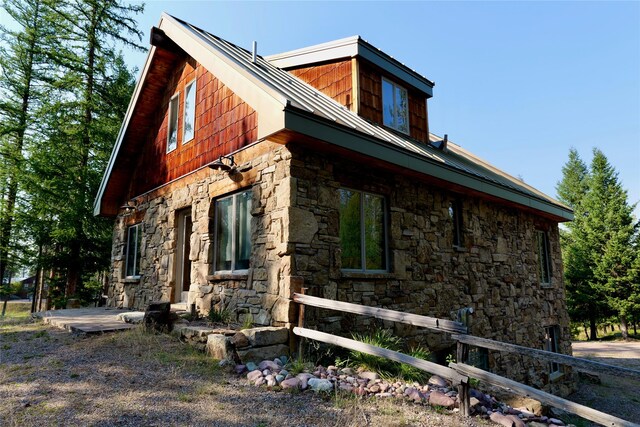 237 N Monture Ct, Seeley Lake, MT 59868 - view of property exterior featuring stone siding
