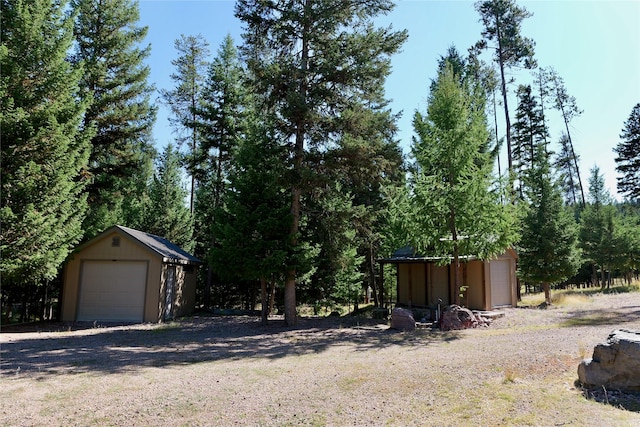 237 N Monture Ct, Seeley Lake, MT 59868 - view of yard featuring an outdoor structure and a detached garage