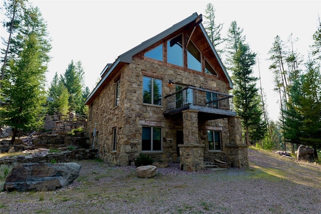 237 N Monture Ct, Seeley Lake, MT 59868 - back of property with a balcony and stone siding
