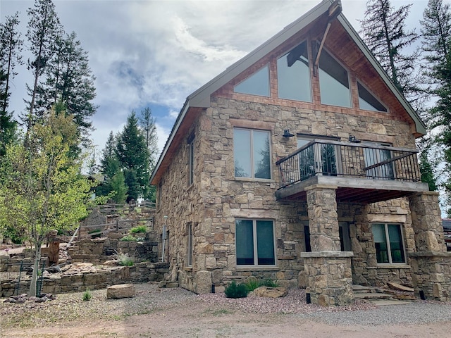 237 N Monture Ct, Seeley Lake, MT 59868 - view of side of home with a balcony and stone siding