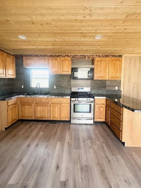 2900 S Montana St Unit 14, Butte, MT 59701 - kitchen featuring stainless steel range with gas stovetop, wooden ceiling, a sink, wood finished floors, and dark countertops
