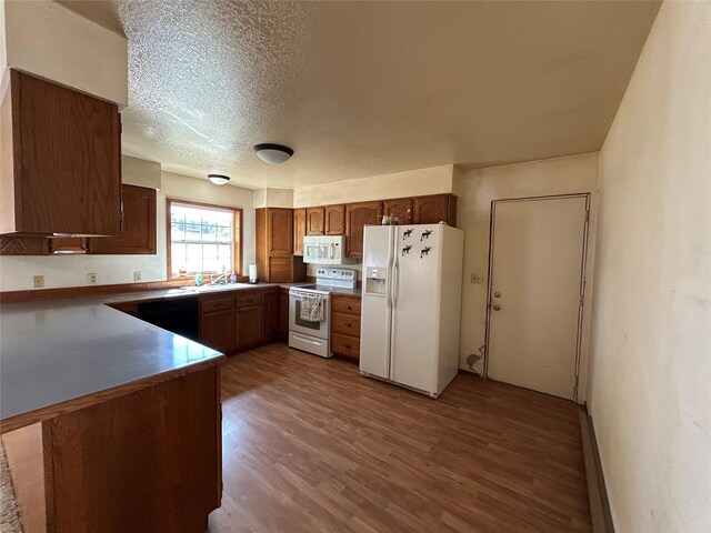 5061 Falcon Ln, Stevensville, MT 59870 - kitchen with white appliances, dark wood-type flooring, a sink, and a textured ceiling
