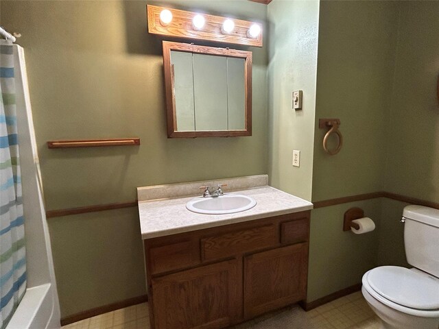 5061 Falcon Ln, Stevensville, MT 59870 - full bathroom featuring toilet, vanity, and tile patterned floors