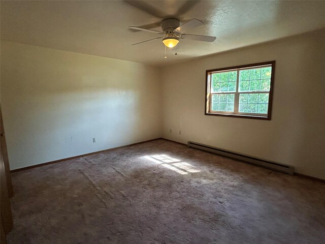 5061 Falcon Ln, Stevensville, MT 59870 - carpeted empty room with a baseboard heating unit, ceiling fan, and baseboards