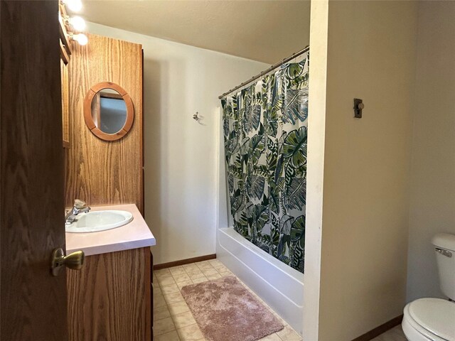 5061 Falcon Ln, Stevensville, MT 59870 - bathroom with toilet, shower / tub combo, vanity, tile patterned floors, and baseboards