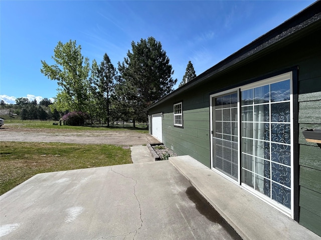5061 Falcon Ln, Stevensville, MT 59870 - view of patio featuring an attached garage and driveway