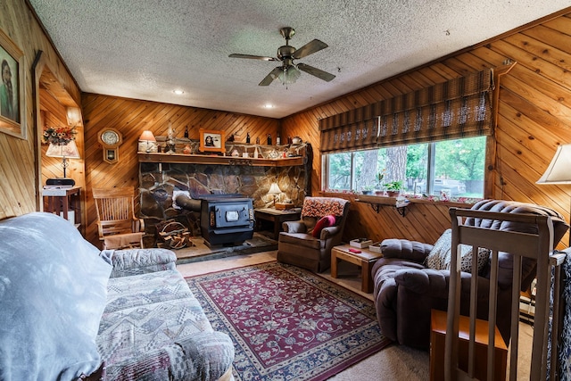 521 Clay St, Thompson Falls, MT 59873 - living area with a wood stove, wooden walls, a textured ceiling, ceiling fan, and recessed lighting