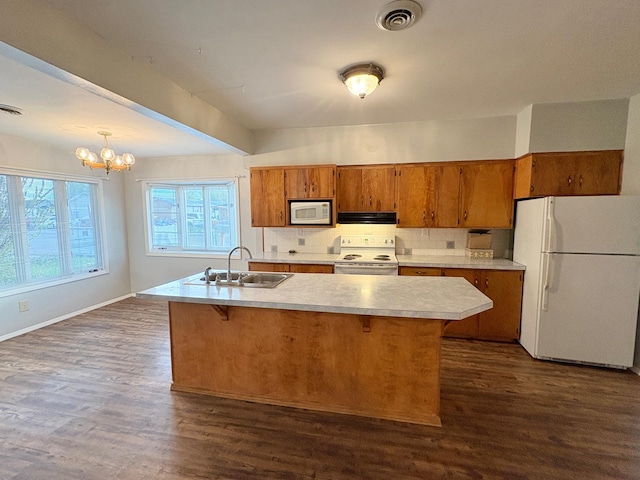 330 N Walnut St, Dillon, MT 59725 - kitchen featuring white appliances, a sink, exhaust hood, brown cabinetry, and light countertops