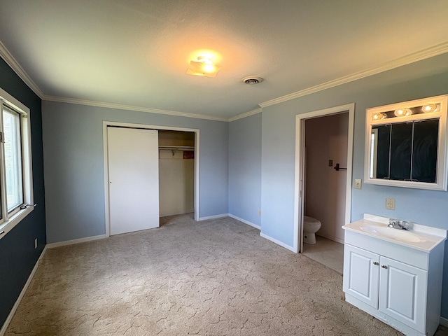 330 N Walnut St, Dillon, MT 59725 - unfurnished bedroom with ornamental molding, light colored carpet, a closet, a sink, and baseboards