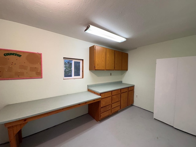 330 N Walnut St, Dillon, MT 59725 - unfurnished office with built in study area, finished concrete floors, and a textured ceiling