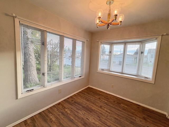 330 N Walnut St, Dillon, MT 59725 - unfurnished dining area featuring a chandelier, baseboards, and dark wood finished floors