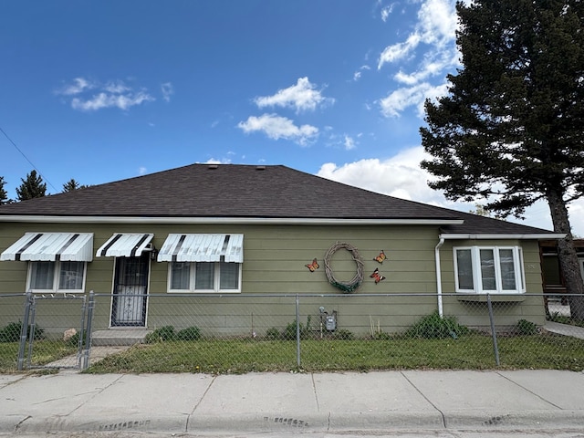 330 N Walnut St, Dillon, MT 59725 - view of side of property with a fenced front yard and a shingled roof