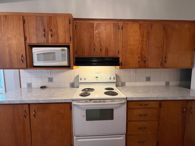 330 N Walnut St, Dillon, MT 59725 - kitchen with white appliances, range hood, light countertops, and backsplash