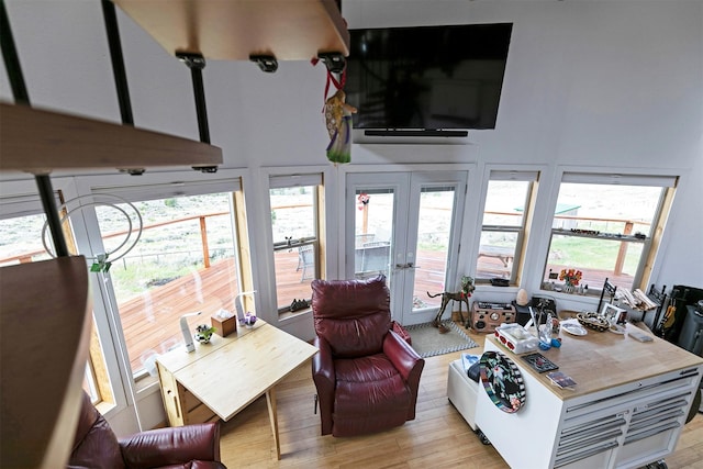 2879 Soft Rock Rd, Corvallis, MT 59828 - living room featuring light wood-style flooring, french doors, and a towering ceiling