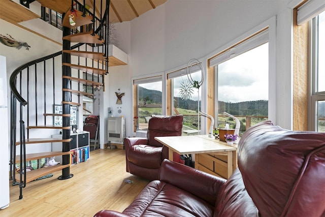 2879 Soft Rock Rd, Corvallis, MT 59828 - living room with high vaulted ceiling, wood finished floors, and stairs