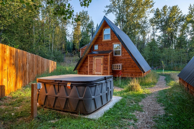 155 Seville Ln, Coram, MT 59913 - back of property with a hot tub and metal roof