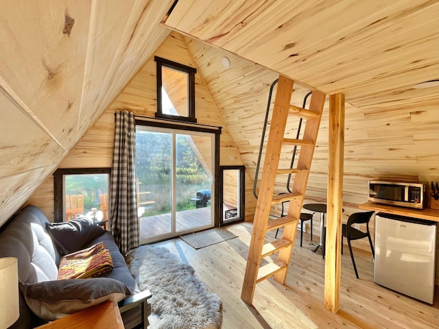 155 Seville Ln, Coram, MT 59913 - living area featuring wood walls, lofted ceiling, wooden ceiling, and hardwood / wood-style flooring