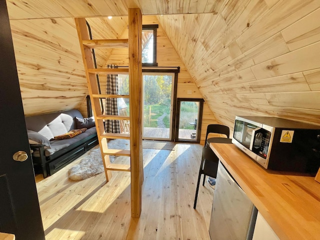 155 Seville Ln, Coram, MT 59913 - bedroom with wooden ceiling, lofted ceiling, multiple windows, wood walls, and hardwood / wood-style floors