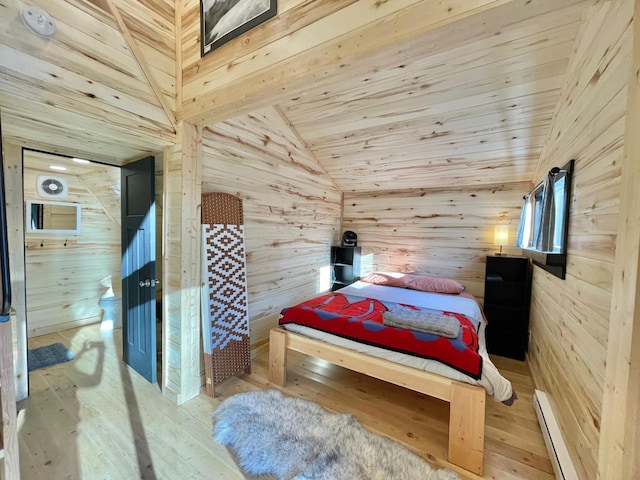 155 Seville Ln, Coram, MT 59913 - bedroom featuring baseboard heating, wood walls, wood-type flooring, lofted ceiling, and wooden ceiling