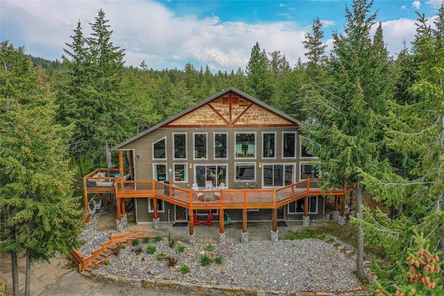 277 Ridge Loop Rd, Rexford, MT 59930 - rear view of house featuring stairs, a wooden deck, and a wooded view