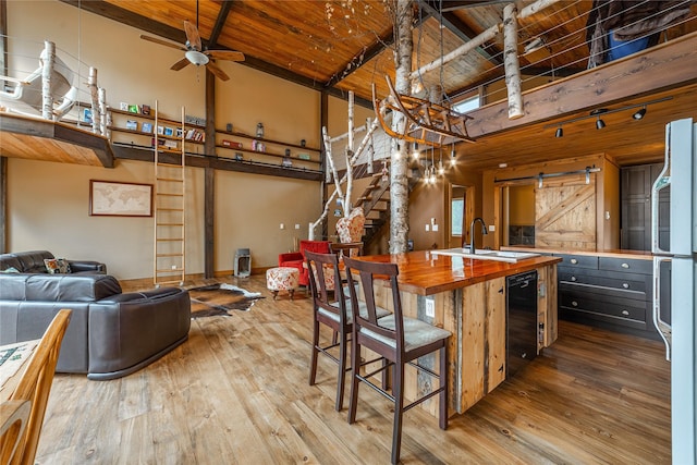 277 Ridge Loop Rd, Rexford, MT 59930 - kitchen with wood counters, a sink, beverage cooler, wood-type flooring, and a ceiling fan